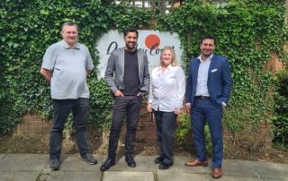 Humza Yousaf MSP with Darnley Court Care Home Staff, standing outside next to their welcome sign